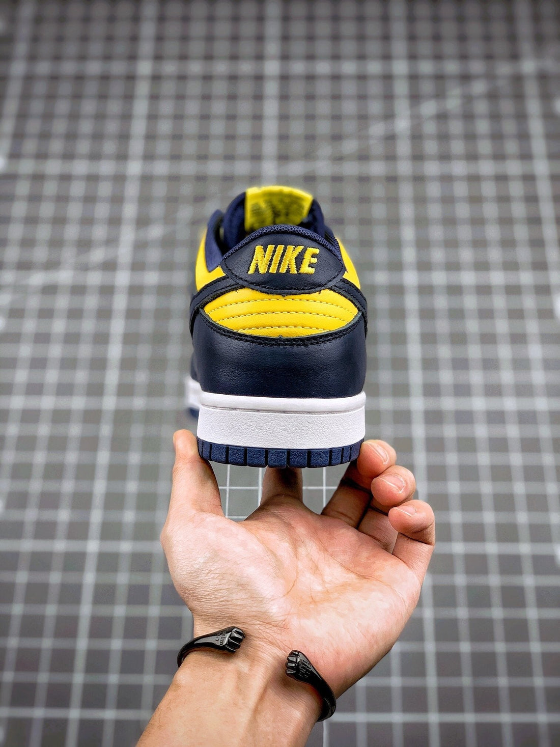 NIKE DUNK LOW "MICHIGAN" : Nike Dunk Low 'Michigan' sneaker featuring Varsity Maize leather upper with Midnight Navy overlays a