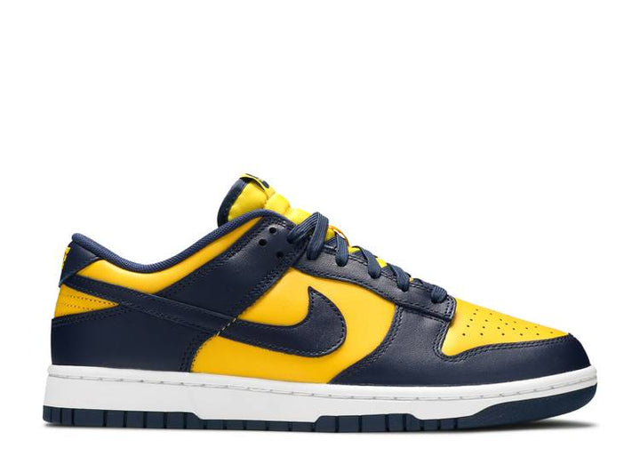 NIKE DUNK LOW "MICHIGAN" Nike Dunk Low 'Michigan' sneaker featuring Varsity Maize leather upper with Midnight Navy overlays a