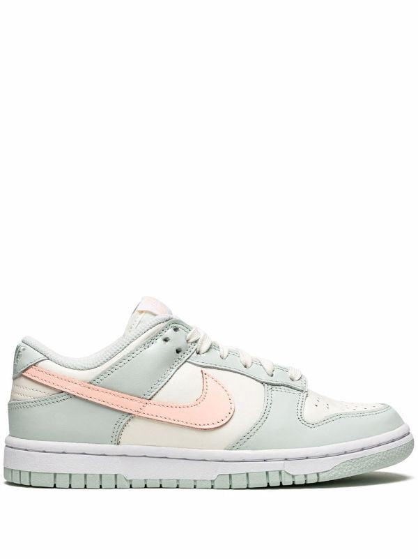 NIKE DUNK LOW Barely Green Nike Dunk Low 'Barely Green' sneaker featuring pastel green leather upper with peach-colored Swooshes.  The image showcases the Nike Dunk Low 'Barely Green' sneaker, highlighting its pastel green leather upper complemented by peach-colored Swooshes and a white midsole. The design offers a fresh and subtle aesthetic, perfect for various styles.

